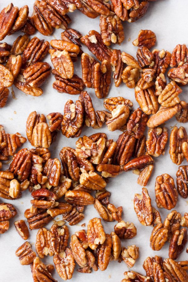 Simply delicious Candied Maple Pecans are pecans coated with a sweet chewy maple coating. Gluten free and vegan these nuts are a healthy treat and addicting!