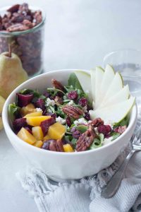 Delicious seasonal Beet, Pear, and Maple Pecan Salad is packed with flavor, texture, and nutrtion. Great for a quick and easy weeknight dinner or impress dinner guests or serve at a get together. Gluten free and vegan friendly.