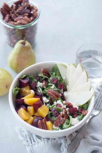 Delicious seasonal Beet, Pear, and Maple Pecan Salad is packed with flavor, texture, and nutrtion. Great for a quick and easy weeknight dinner or impress dinner guests or serve at a get together. Gluten free and vegan friendly.