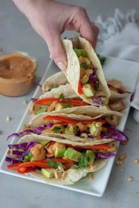 hand holding a Vegan Thai Taco