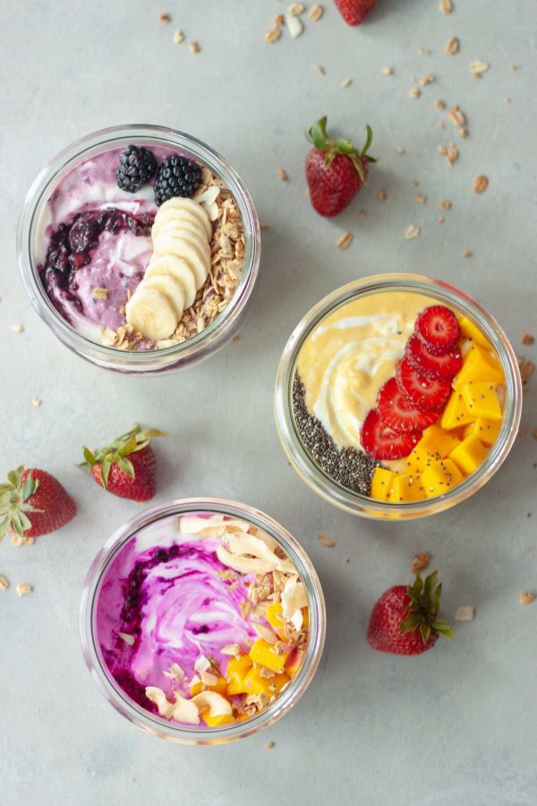 3 yogurt bowls, mango, strawberries, blackberries, pitaya, mango, granola, bananas, chia