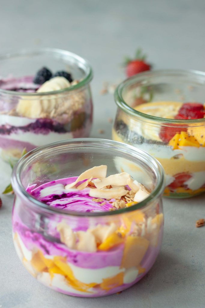 3 yogurt bowls, mango, strawberries, blackberries, pitaya, mango, granola, bananas, chia