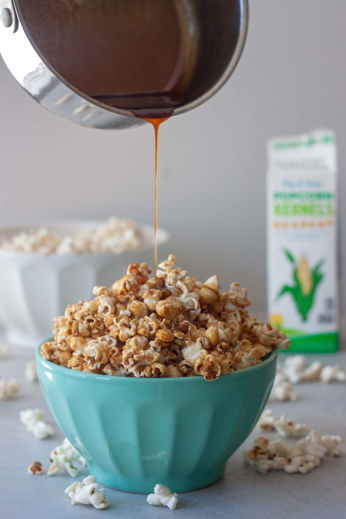 Drizzling caramel, bowl of Healthier Caramel Popcorn