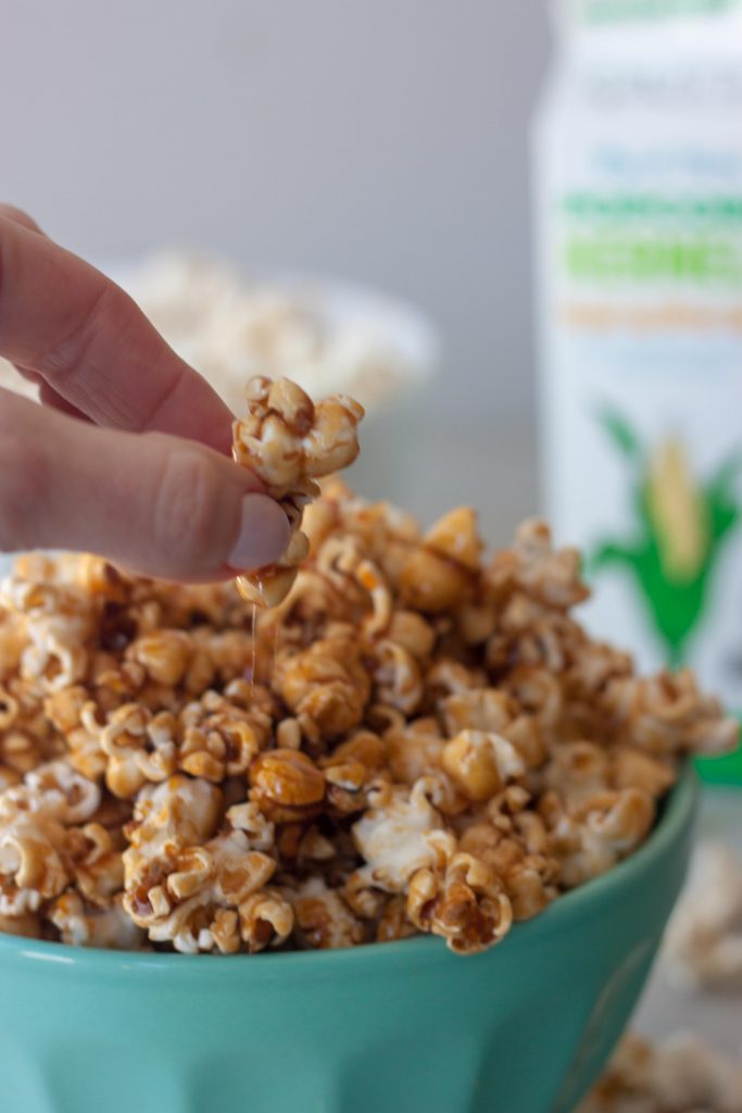 hand picking up Healthier Caramel Popcorn