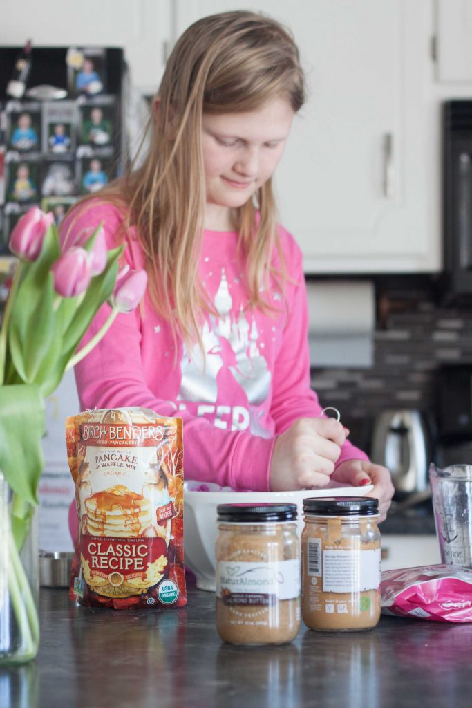 girl in the kitchen making pancakes