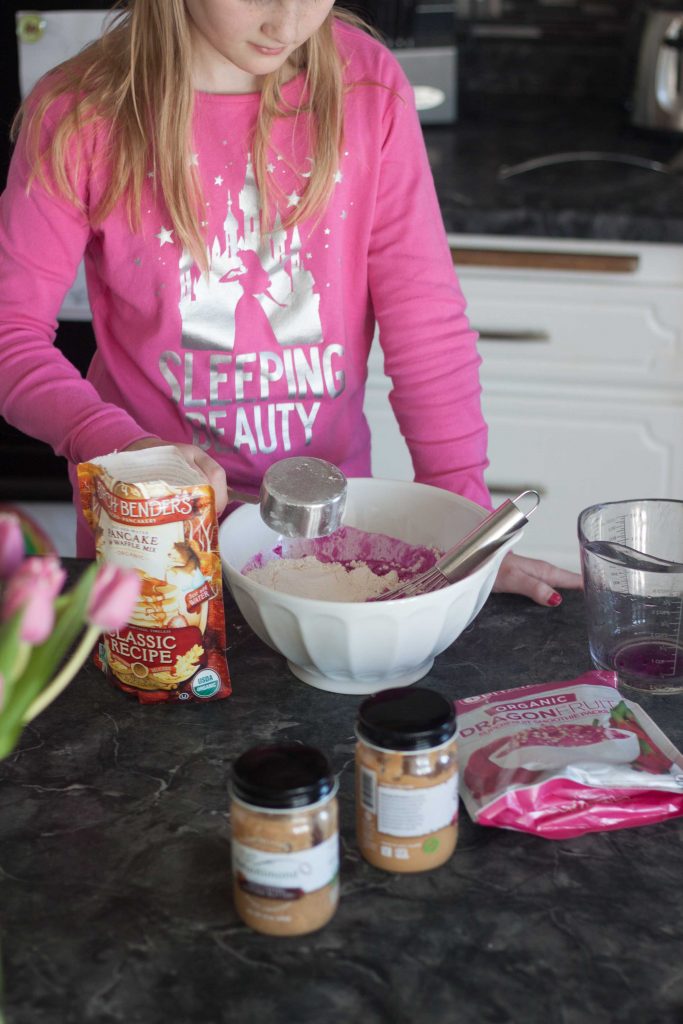 girl in the kitchen making pancakes