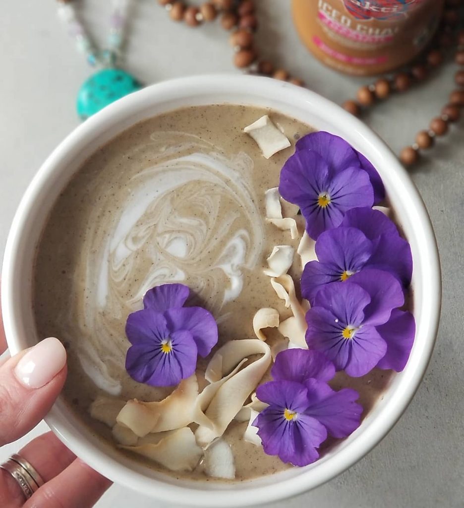 Sweet Chai Of Mine Smoothie Bowl with coconut yogurt, toasted coconut chips, and edible flowers