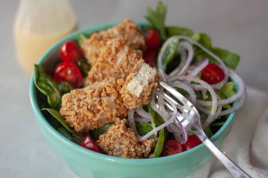 Inside of Pretzel Crusted Tofu on a salad