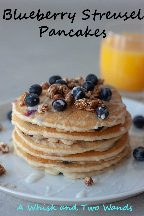 Blueberry Streusel Pancakes Fluffy stack of gluten free vegan friendly pancakes bursting with blueberries with a hint of everything you love from a blueberry streusel muffin including the crumble topping and icing. A stack is sure to sweeten up any morning!