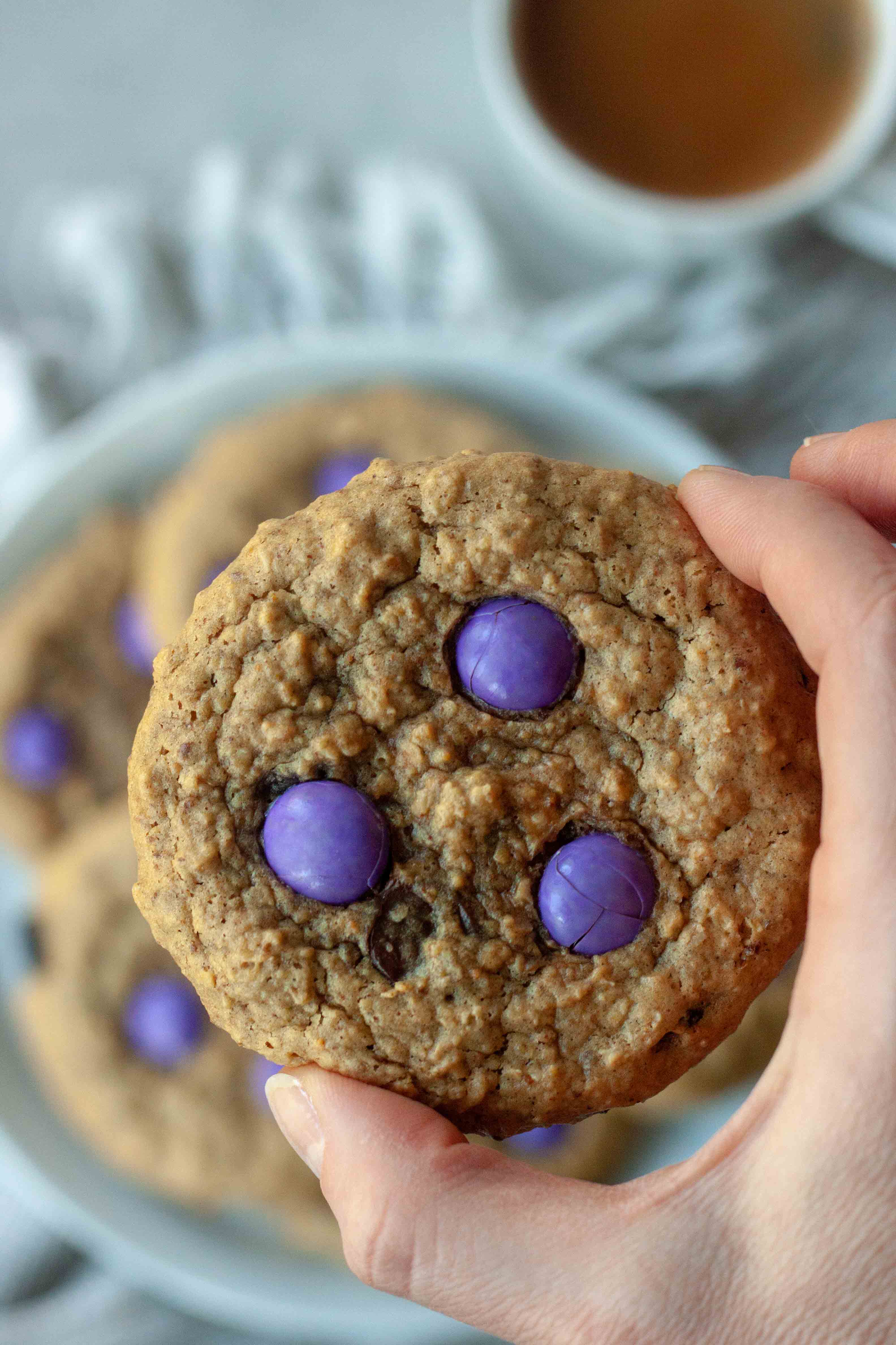 Holding a Milk Monster Cookie.