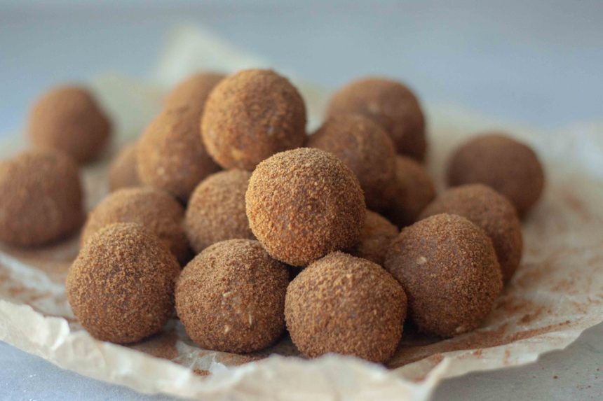 Pile of Cinnamon Sweet Potato No Bake Donut Holes and cinnamon sugar