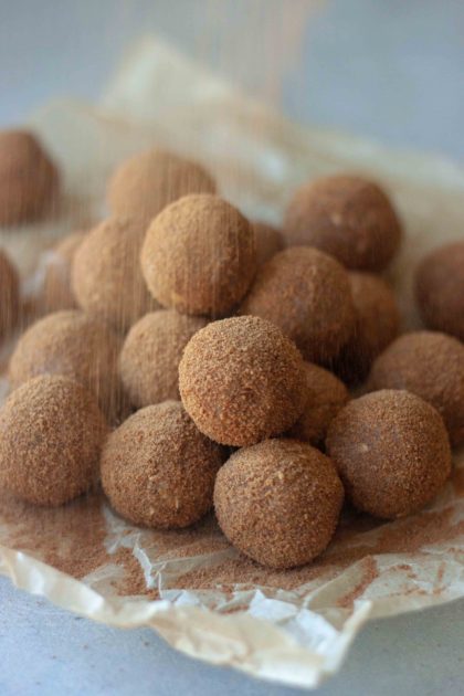 Pile of Cinnamon Sweet Potato No Bake Donut Holes and cinnamon sugar