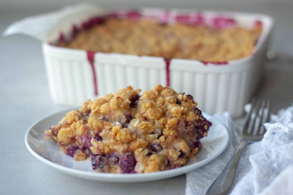 Piece of Sweet Corn Blueberry Crisp with pan behind