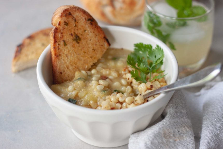 Bowl of Spicy Sweet Corn Soup with Sautéed Chili Lime Corn with toasted bread and spoon