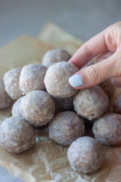 Hand grabbing a No Bake Maple Glazed Cinnamon Donut Holes