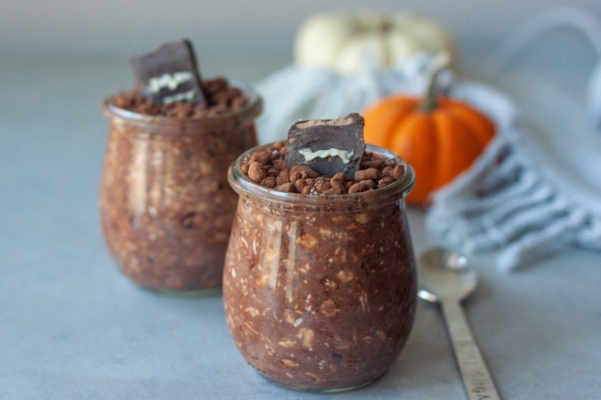 2 Overnight Oat Graveyard Cups with mini pumpkins and spoon