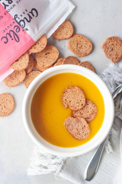 Golden Turmeric Butternut Squash Soup topped with Angelic Bakehouse Sprouted Pickled Sweet Onion Crisps