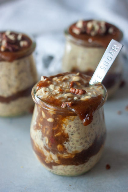 Sticky Toffee Pudding Overnight Oats in jars with spoon