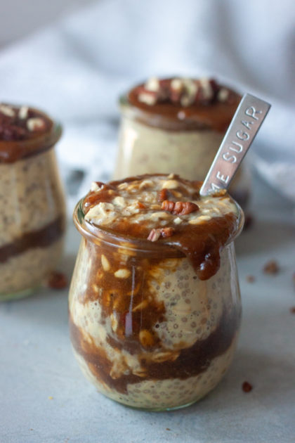 Sticky Toffee Pudding Overnight Oats in jars with spoon