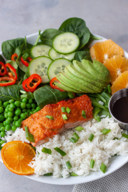 Orange Salmon Asian Veggie Bowls are one of the ways to customize my Asian Veggie Bowls adding salmon! Simple, anything but boring, delicious grain bowls that are packed with whole food flavor and easily customizable for the whole family. Easy to make, can be prepped ahead for a quick weeknight dinner.