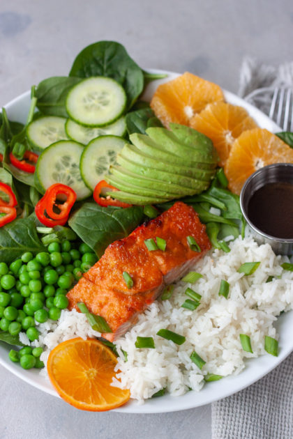 Orange Salmon Asian Veggie Bowls are one of the ways to customize my Asian Veggie Bowls adding salmon! Simple, anything but boring, delicious grain bowls that are packed with whole food flavor and easily customizable for the whole family. Easy to make, can be prepped ahead for a quick weeknight dinner.