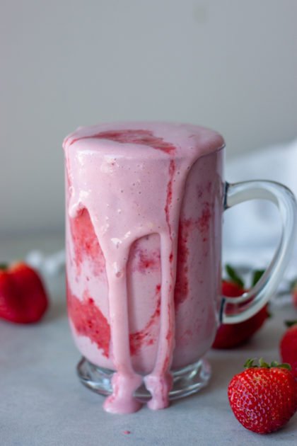 Double Strawberry Shake spilling over out of mug