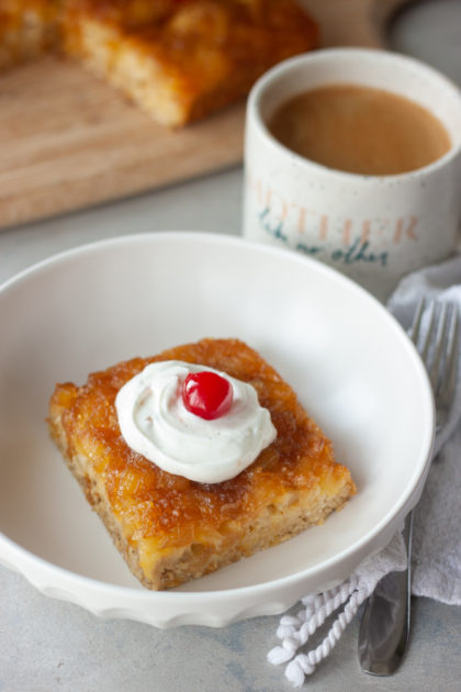 Pineapple Upside-Down Oatmeal Cake in bowl with coffee