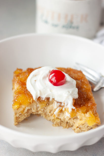 Pineapple Upside-Down Oatmeal Cake in bowl with bite and fork