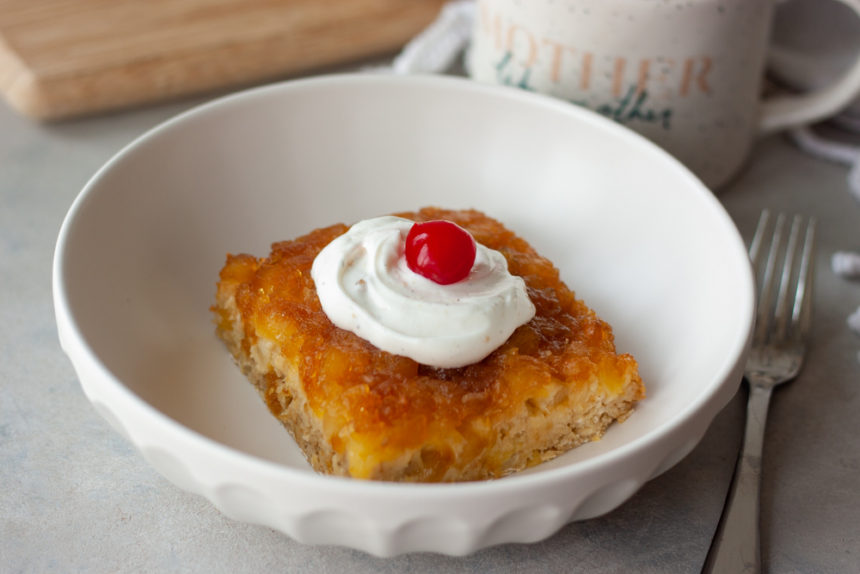 Pineapple Upside-Down Oatmeal Cake in bowl with fork and coffee cup