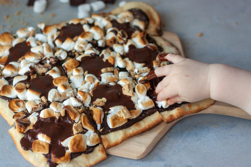 Hand grabbing slice of Sourdough S'more Pizza