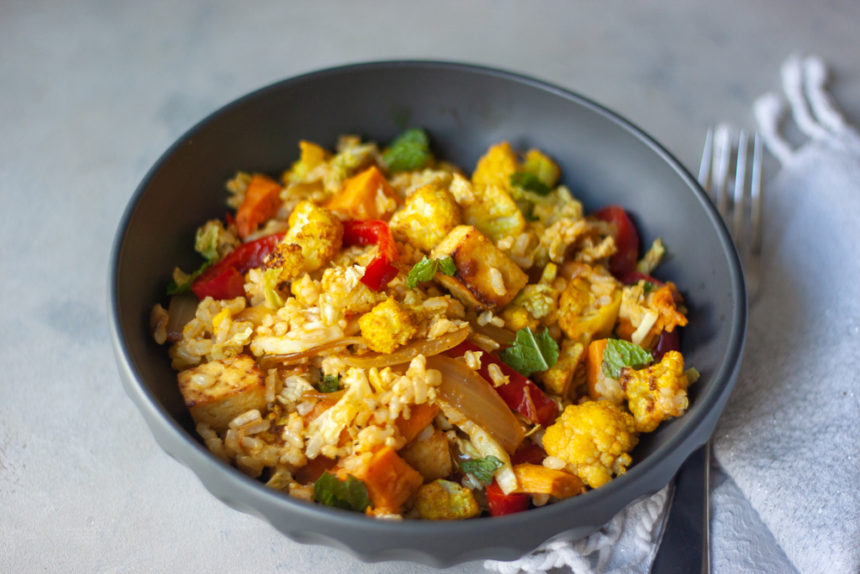 Flavor and nutrition packed gluten free and vegan Curry Cauliflower Grain Bowl 2.0 is meal prep friendly and great for lunch or dinner. Brown rice, roasted curry cauliflower, sauteed red pepper and onions, roasted sweet potatoes, optional crispy citrus tofu, fresh mint, and a Ginger Curry Dressing!