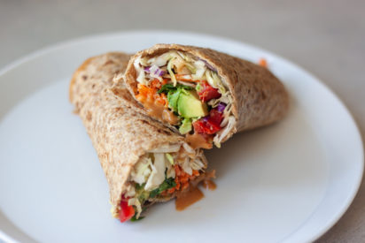 Spice things up for lunch with Sprouted Thai Veggie Wraps with Peanut Sauce! Sprouted wraps packed with sweet potato, carrots, peppers, avocado, and Thai Peanut Sauce! Not a wrapper dip all the veggies in Thai Peanut Sauce or make a salad bulking up veggies, adding mango and or optional peanuts. Vegan and gluten free friendly.