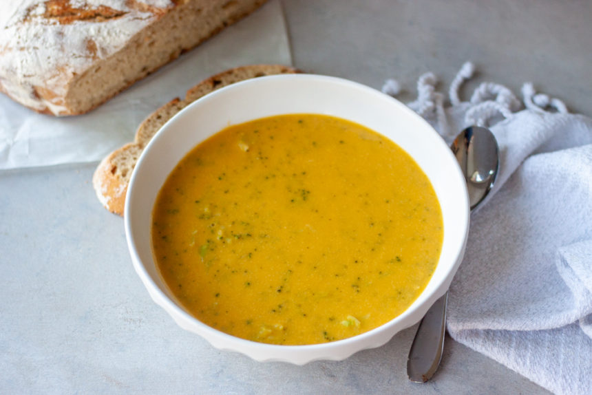 Bowl of Cheesy Broccoli No Cheese Soup with bread