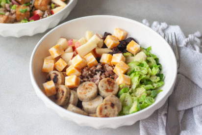 Wild Child Bowl is a blend of wild rice, chicken sausage, apples, brussels, cheese, and dried cranberries