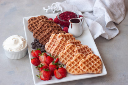 Strawberry and Chocolate Waffle Brunch Board with berries, jam, chocolate, and whipped cream