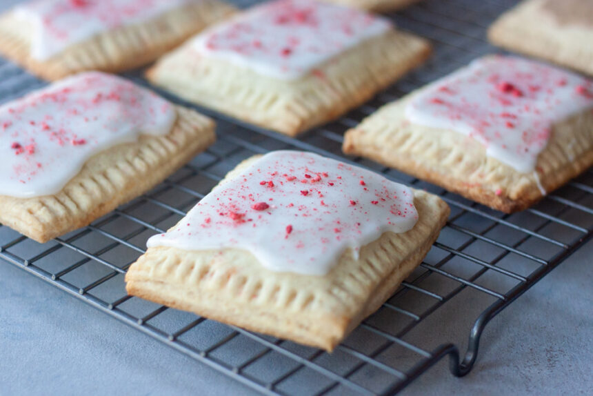 Homemade Strawberry Pop Tarts are a simple , fresh, and healthier twist on classic pop tarts that you can customize. Made easy with pancake mix these pop tarts are vegan and there are links to paleo, and gluten free options.