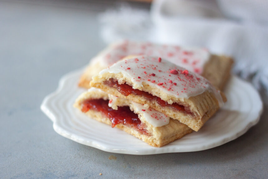 Homemade Strawberry Pop Tarts are a simple , fresh, and healthier twist on classic pop tarts that you can customize. Made easy with pancake mix these pop tarts are vegan and there are links to paleo, and gluten free options.