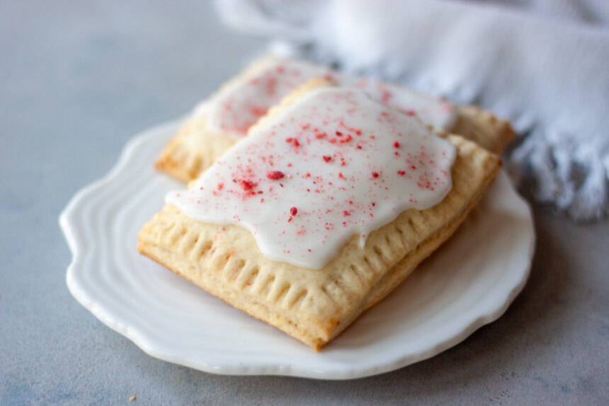 Homemade Strawberry Pop Tarts are a simple , fresh, and healthier twist on classic pop tarts that you can customize. Made easy with pancake mix these pop tarts are vegan and there are links to paleo, and gluten free options.